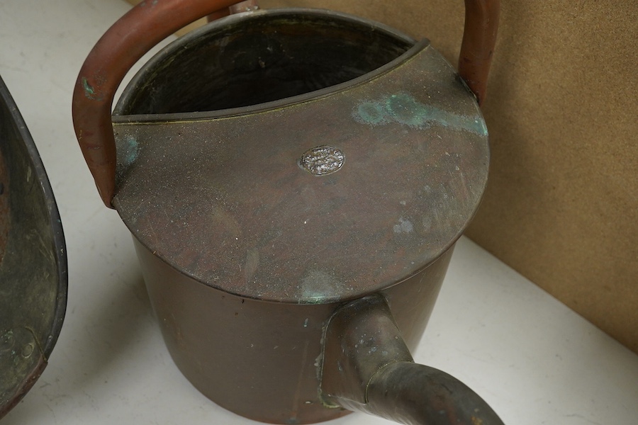 A copper watering can and a helmet coal scuttle, watering can 40cm high. Condition - interior of coal scuttle rusty, both need cleaning